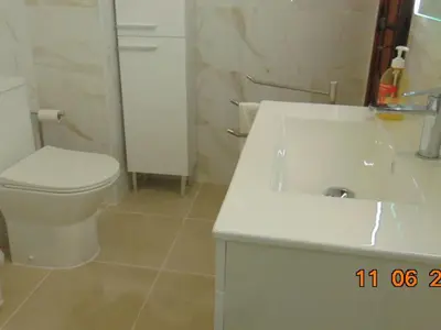 a bathroom with a white toilet and a sink at Apartment NASCER-DO-SOL by Interhome in Quarteira