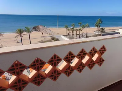 a view of the beach from the balcony of a resort at Apartment NASCER-DO-SOL by Interhome in Quarteira