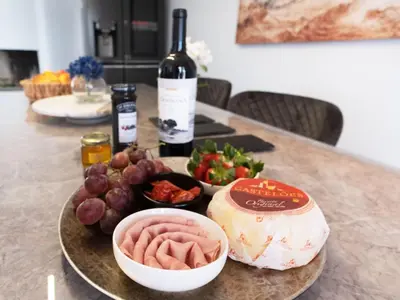 a table with a plate of food and a bottle of wine at Holiday Home Aldeia Do Mar by Interhome in Vilamoura