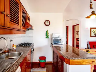 a kitchen with a sink and a microwave at Holiday Home Lotus Villa 2- Albufeira by Interhome in Albufeira