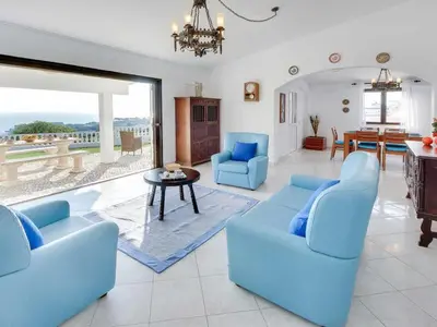 a living room with blue chairs and a table at Holiday Home Chalet Villa Brigida mit privatem Pool by Interhome in Albufeira