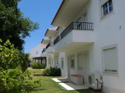 a white building with a balcony on the side at Apartment Wohnung mit Terrasse by Interhome in Albufeira