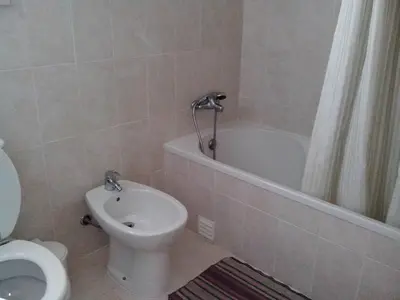 a bathroom with a toilet and a tub and a sink at Apartment Wohnung mit Terrasse by Interhome in Albufeira