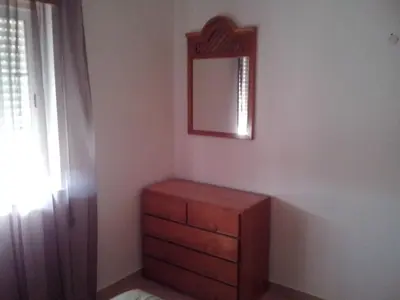 a bedroom with a dresser and a mirror on the wall at Apartment Wohnung mit Terrasse by Interhome in Albufeira