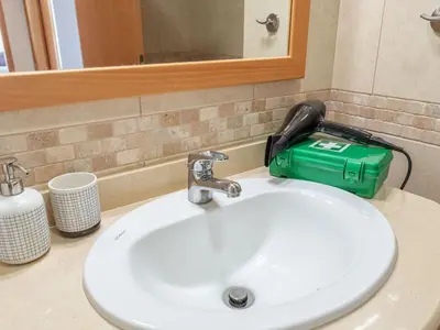 a bathroom sink with a blow dryer sitting on top of it at Apartment Elena 2 mit Blick auf das Wasser by Interhome in Albufeira