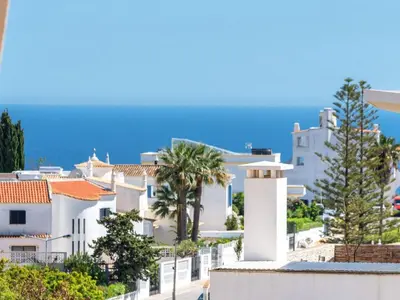 a view of houses and palm trees from a building at Apartment Elena 2 mit Blick auf das Wasser by Interhome in Albufeira
