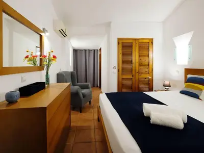 a bedroom with a bed and a desk and a chair at Holiday Home Lotus Villa- Albufeira by Interhome in Albufeira