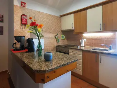 a kitchen with a counter with a vase of flowers on it at Holiday Home Lotus Villa- Albufeira by Interhome in Albufeira