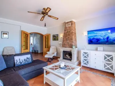 a living room with a couch and a fireplace at Holiday Home Villa Monte Alegrete by Interhome in Loulé
