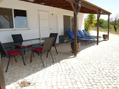 a patio with chairs and a table and a building at Holiday Home Villa Monte Alegrete by Interhome in Loulé