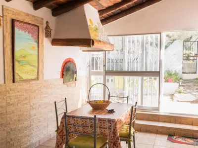 a dining room with a table and chairs and a window at Holiday Home Berghütte Villa Romao by Interhome in Barranco de Apra