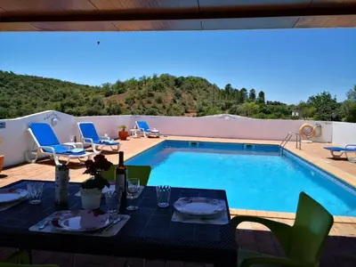 a patio with a table and a swimming pool at Holiday Home Berghütte Villa Romao by Interhome in Barranco de Apra