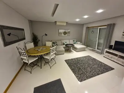 a living room with a table and chairs and a couch at Garden Hill Haven - Old Town Albufeira - Sea View in Albufeira