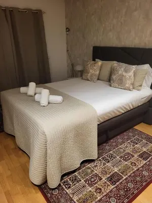 two beds with white sheets and towels on them at Garden Hill Haven - Old Town Albufeira - Sea View in Albufeira