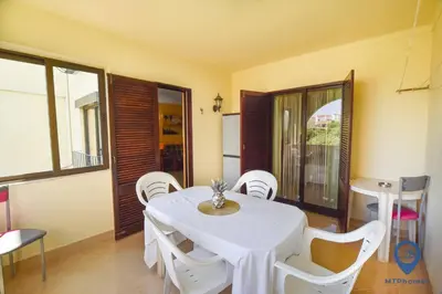 a dining room with a white table and chairs at Vitoria 1 by MTPhomes in Albufeira