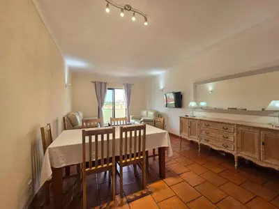 a dining room with a table and a mirror at Vitoria 2 by MTPhomes in Albufeira