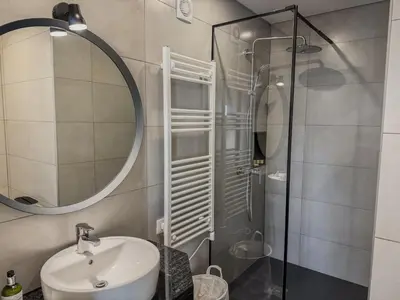 a bathroom with a sink and a shower with a mirror at Villa Nova En-suite luxury, private pool, sea view in Albufeira