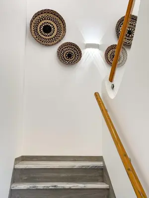 a staircase with plates on the wall at Villa Nova En-suite luxury, private pool, sea view in Albufeira