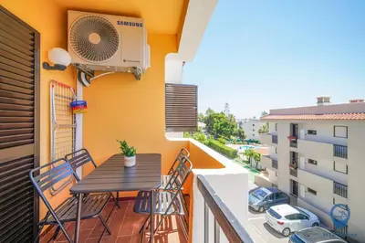 a balcony with a table and chairs on a balcony at Bordalo by MTPhomes in Albufeira