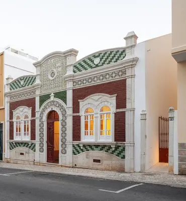 a brick building with a tiled facade on a street at Casa 1923 by MY CHOICE in Faro