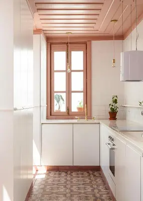 a white kitchen with a window and a sink at Casa 1923 by MY CHOICE in Faro