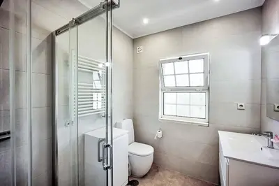 a bathroom with a tub and a sink and a mirror at Zen Balaia in Olhos de Água