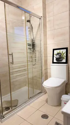 a bedroom with a bed with a picture on the wall at Maple Apartment in Albufeira