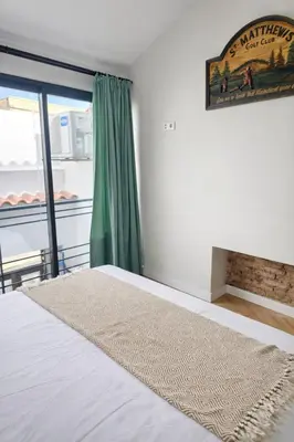 a bedroom with a bed and a green curtain at Elegant City Center Loft in Faro