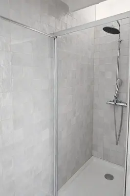 a bathroom with a shower with a glass door at Elegant City Center Loft in Faro
