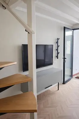 a living room with a flat screen tv on a wall at Elegant City Center Loft in Faro
