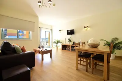 a living room with a table and a couch at Marina Heaven TatiHomes RC in Albufeira