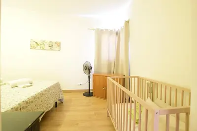 a bedroom with two beds and a crib at Marina Heaven TatiHomes RC in Albufeira