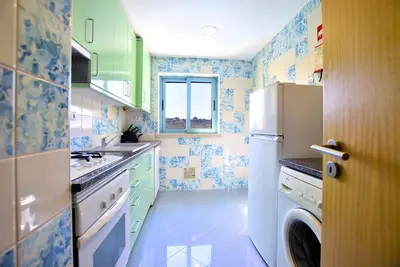 a kitchen with a refrigerator and a window at Marina Sunny Heaven TatiHomes 2 in Albufeira