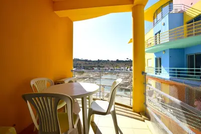 a table and chairs on a balcony with a view at Marina Sunny Heaven TatiHomes 2 in Albufeira