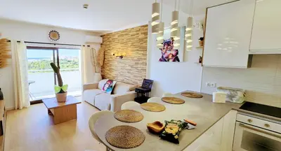 a swimming pool with chairs and an umbrella at Luxury Sea View Apartment in Albufeira