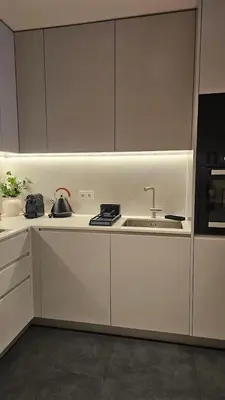 a white kitchen with a sink and a stove at Sweet Horizon in Quarteira