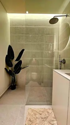 a bathroom with a glass shower with a toilet at Sweet Horizon in Quarteira