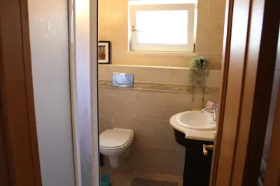 a small bedroom with a yellow bed and a cabinet at Villa Levira with private Pool in Quarteira