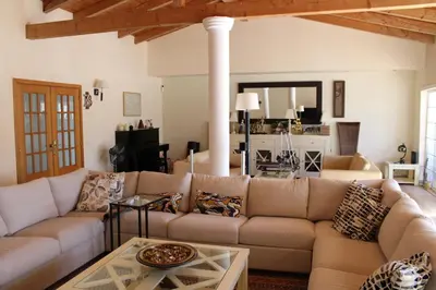a living room with a couch and a table at Villa Levira with private Pool in Quarteira