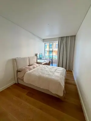 a bedroom with a bed and a large window at Horizon Sand Beachfront apartment - Pool View, Quarteira in Bicas