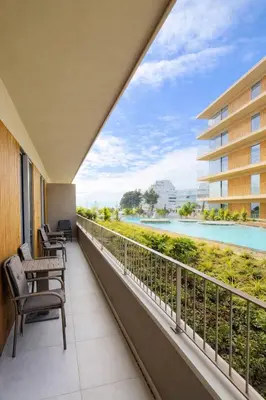 a balcony with chairs and a view of the water at Horizon Sand Beachfront apartment - Pool View, Quarteira in Bicas