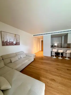 a white living room with a couch and a table at Horizon Sand Beachfront apartment - Pool View, Quarteira in Bicas