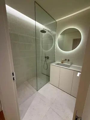 a bathroom with a shower and a sink and a mirror at Horizon Sand Beachfront apartment - Pool View, Quarteira in Bicas