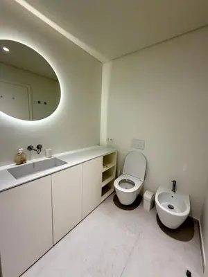 a bathroom with a sink and a toilet and a mirror at Horizon Sand Beachfront apartment - Pool View, Quarteira in Bicas