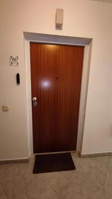 a wooden door in a room with a wall at Linda Vista in Albufeira