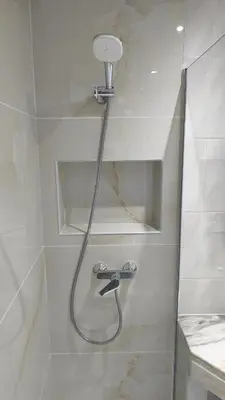 a shower with a shower head in a bathroom at Linda Vista in Albufeira