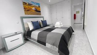 a bedroom with a large bed with blue pillows at Linda Vista in Albufeira