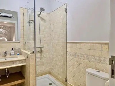 a bathroom with a shower and a sink and a toilet at Villa Golf Gardens - Cleverdetails, Vilamoura in Vilamoura