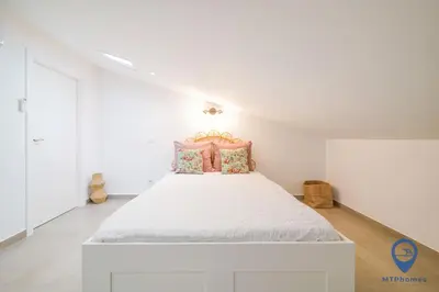 a white bedroom with a large bed in a room at Palmeiras by MTPhomes in Albufeira