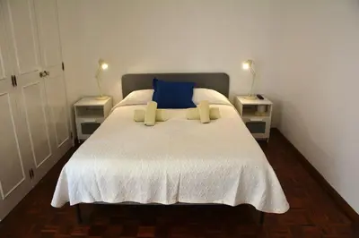 a bedroom with a large bed with two night stands at Blife Chelsya private apartment in Faro
